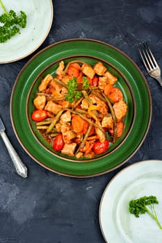 Stewed meat with carrots and green beans. Hot ragout with meat and vegetables.