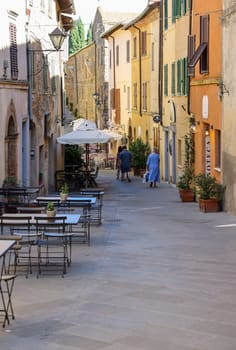 Montalcino, Italy - September 12, 2022: Charming street with bars and wine shops in Montalcino in Tuscany. Italy