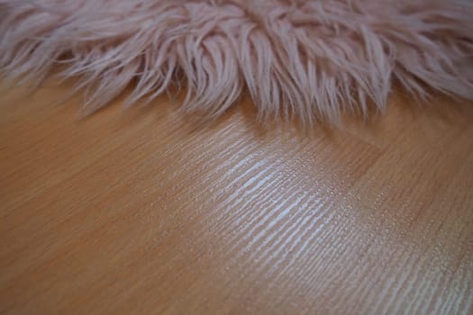 Long pile rug in pink on a beige laminate floor. Feminine interior for a room or bedroom of a girl or woman. Interior design in pink tones. Flooring is laminate. The role of dust mites in allergies