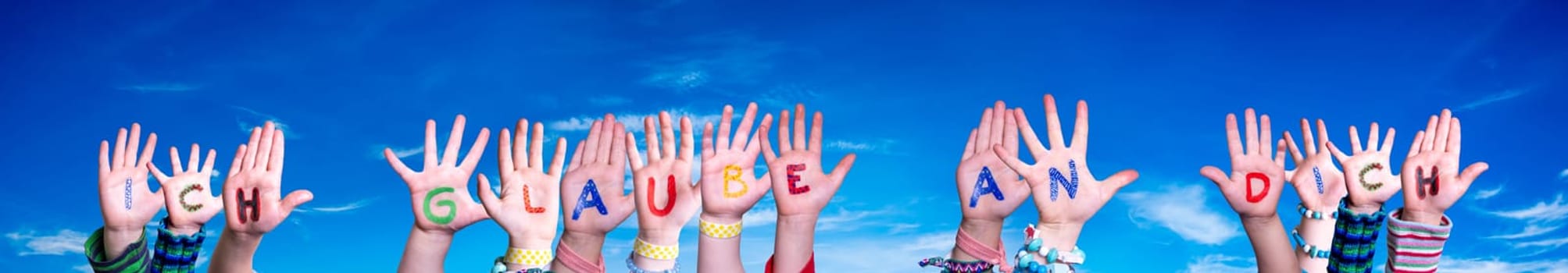 Children Hands Building Colorful German Word Ich Glaube An Dich Means I Believe In You. Blue Sky As Background.