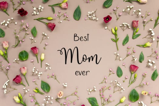 Flower Arrangement With English Text Best Mom Ever. Colorful Spring Blossoms And Flowers Like Roses Building A Frame. Flat Lay With Brown Paper Background
