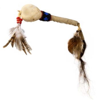 Replica of a North American Indian dance rattle made of gourd with glass beads and feathers, isolated on white