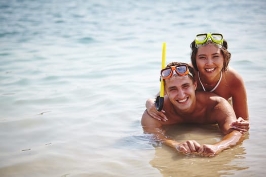 Affectionate scuba divers lying in water