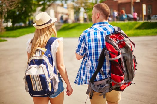 Young man and woman in casualwear traveling in foreign city
