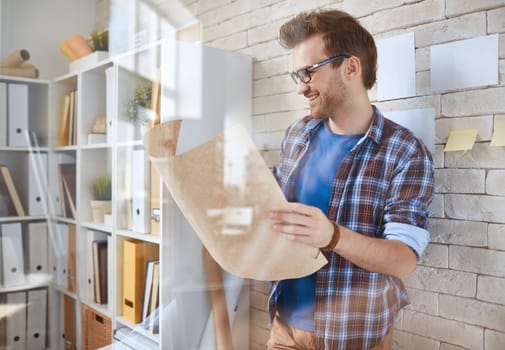 Happy businessman with sketch of construction
