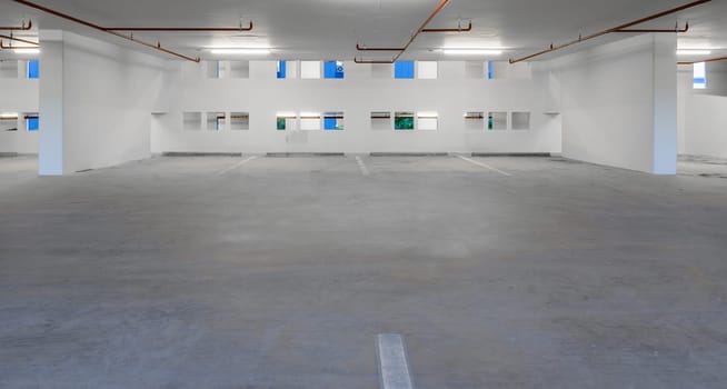 Indoor empty parking lot illuminated at night
