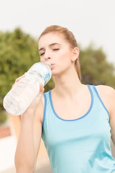 A young athlete takes a drinking break with mineral water