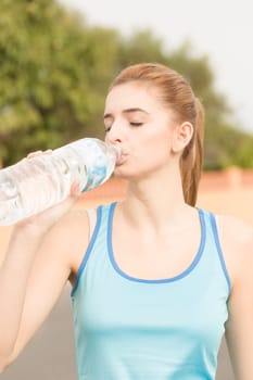 A young athlete takes a drinking break with mineral water
