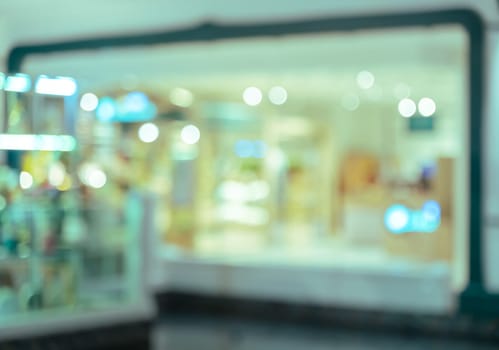 Blurred shopping mall or department store interior background bokeh light