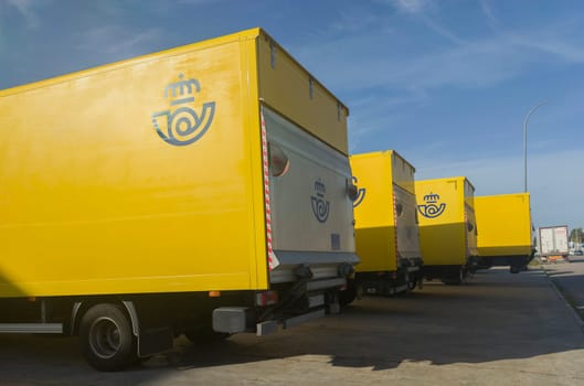 Merida, Spain - February 20th, 2023: Correos trucks fleet parked outdoors. State-owned company responsible for providing postal service in Spain