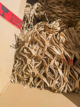 Box with shredded cardboard filler material. Eco-friendly packaging concept