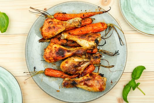 Appetizing chicken legs baked with vegetables. Homemade barbecue
