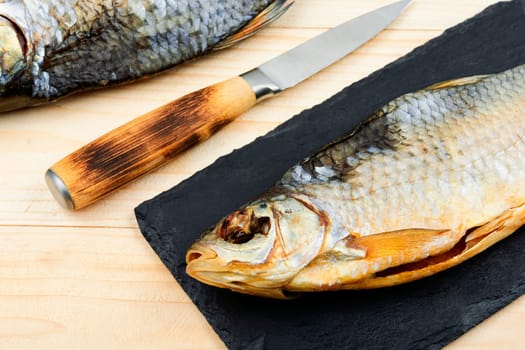 Dried salted fish on the wooden table. Sun dried fish.