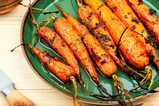 Fried carrots with herbs and spices on the plate