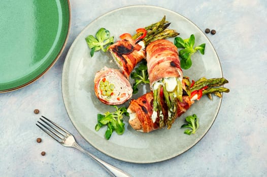 Beef roll wrapped in bacon. Meat stuffed with asparagus and cream cheese.