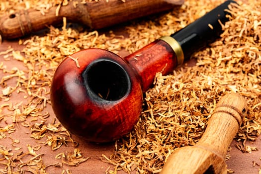 Aroma smoking tobacco and a smoking tube or pipe on the table.