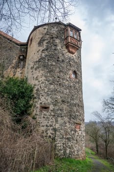 Beautiful old Tower at Ronneburg Castle with balcony during cloudy day, view from low angle, Germany, vertical shot