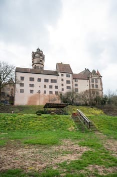 View of the beautiful Ronneburg Castle during cloudy day, meadow in front, low angle view Germany, vertical shot