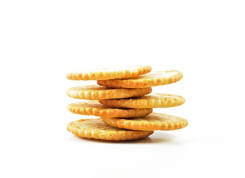 Salty crackers stacked on white background