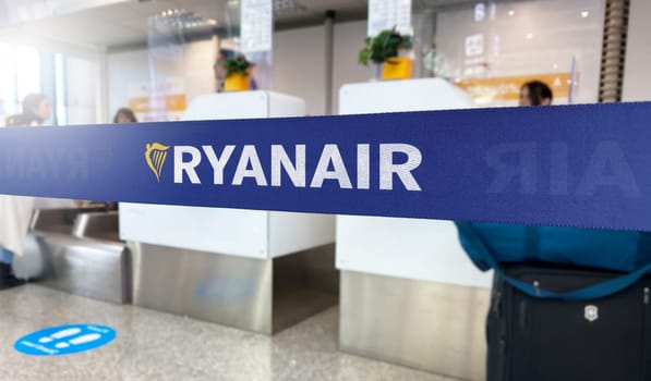 Rome, IT Jan 2023: Blue barrier tape with the Ryanair logo inside an airport. Ryanair is an Irish ultra low-cost carrier. Travel and airport security. Illustrative editorial