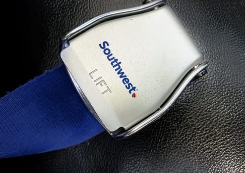 Atlanta, US Jan 2023: detail of the buckle of the seat belt with Southwest airlines logo on an empty seat. Southwest airline is the largest low-cost carrier in the world. Illustrative editorial.