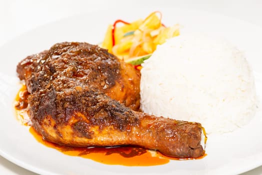 Chicken Rendang served with coconut milk rice and pickled vegetables