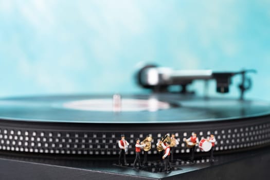Miniature brass band, turntable and blue background
