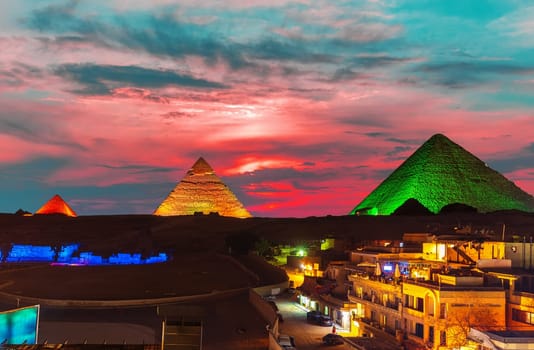 The Great Pyramid complex enlighted at night, Giza, Egypt.