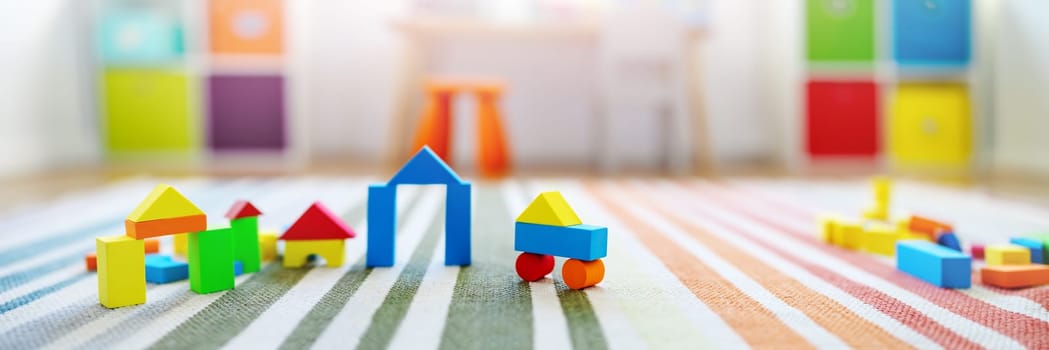 Panoramic background of the colourful blocks in playroom. Concept of the wallpaper and banner.