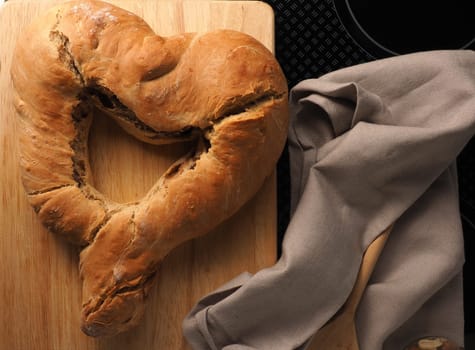 Yeast dough formed into a heart, baked until golden brown, traditional handwork, Easter bread