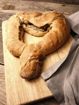 Yeast dough formed into a heart, baked until golden brown, traditional handwork, Easter bread