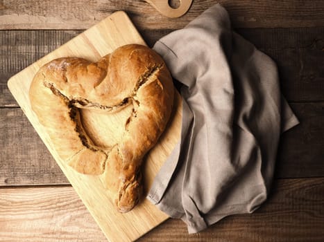 Yeast dough formed into a heart, baked until golden brown, traditional handwork, Easter bread