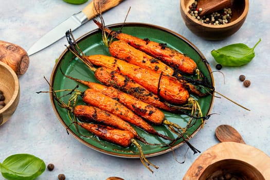 Roasted with herbs and spices whole carrots. Vegetarian healthy appetize.