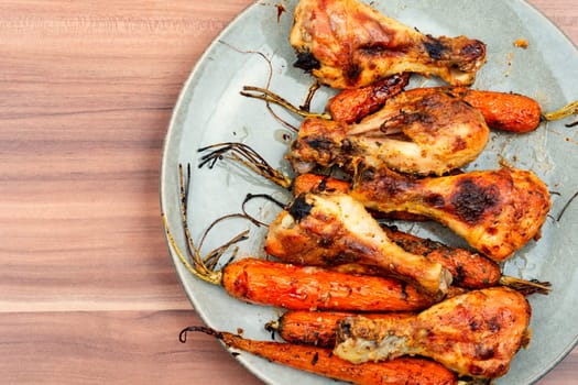 Grilled chicken drumsticks, roast chicken legs with carrots