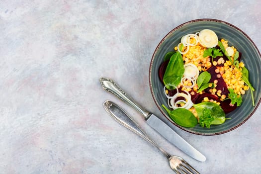 Salad with beets,red lentils, onions and herbs in bowl. Healthy eating. Flat lay