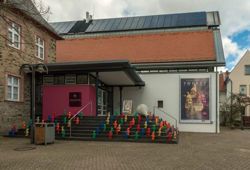 Colorful garden gnomes stand on a staircase in front of the Citymuseum Hofheim am Taunus