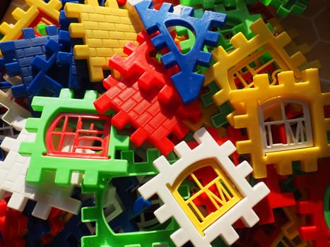 children's designer toy. Plastic bright multi-colored blocks for playing and developing the imagination and fine motor skills of the child's hands. Toy house construction.