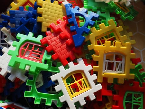 children's designer toy. Plastic bright multi-colored blocks for playing and developing the imagination and fine motor skills of the child's hands. Toy house construction.