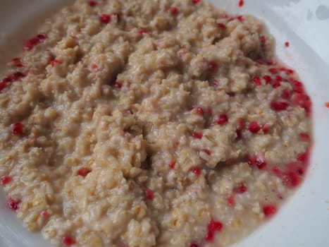 Organic Granola Cereal with oats, powdered sugar and dry raspberries. Healthy muesli spiced with water. Low-calorie diet. Anti-diabetes.