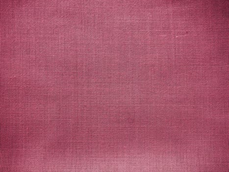 Cloth close-up. Interlacing of threads. A piece of pink fabric. Fabric background. Copy space.