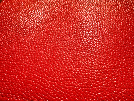 Red or pink leather. Material for fashion accessories, for sewing leather and suede products, furniture upholstery. Natural leather texture. Magenta or fuchsia