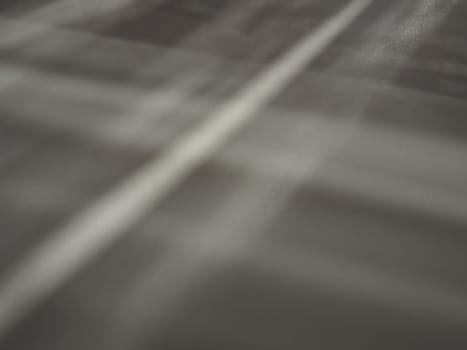 Illumination rays on gray surface. Abstract rays of light and lens flare on a gray background. Vertical, horizontal and diagonal light stripes.