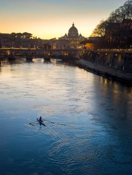Evening view at the Angelo bridge and St. Peter's Basilica in Rome, Italy