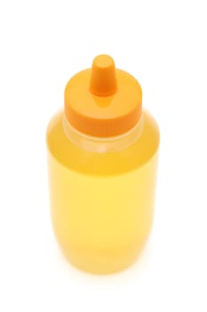 Plastic bottle of honey on white background