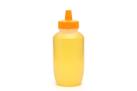 Plastic bottle of honey on white background
