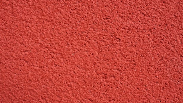Background, texture of cement plaster of red color. Plastering of internal premises and external facades of buildings. Interior in red