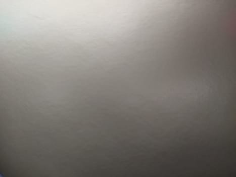silver gray background with gradient. Light reflective colored paper with a metallic sheen. Background.