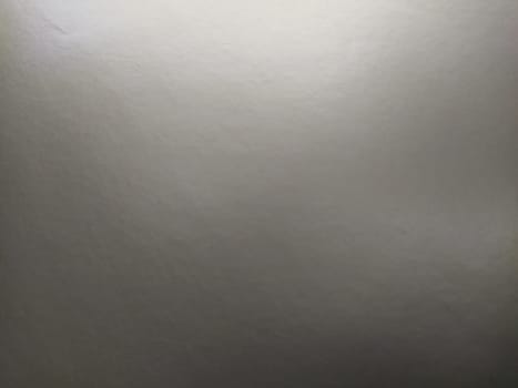 silver gray background with gradient. Light reflective colored paper with a metallic sheen. Background.
