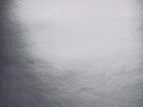 silver gray background with gradient. Light reflective colored paper with a metallic sheen. Background.