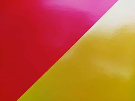 Yellow-pink bright background. Diagonally laid sheets of colored paper with a gradient and light flare.